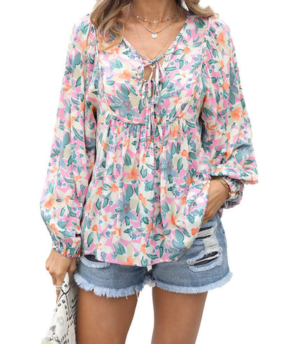Floral print tie neck blouse with ruffle peplum