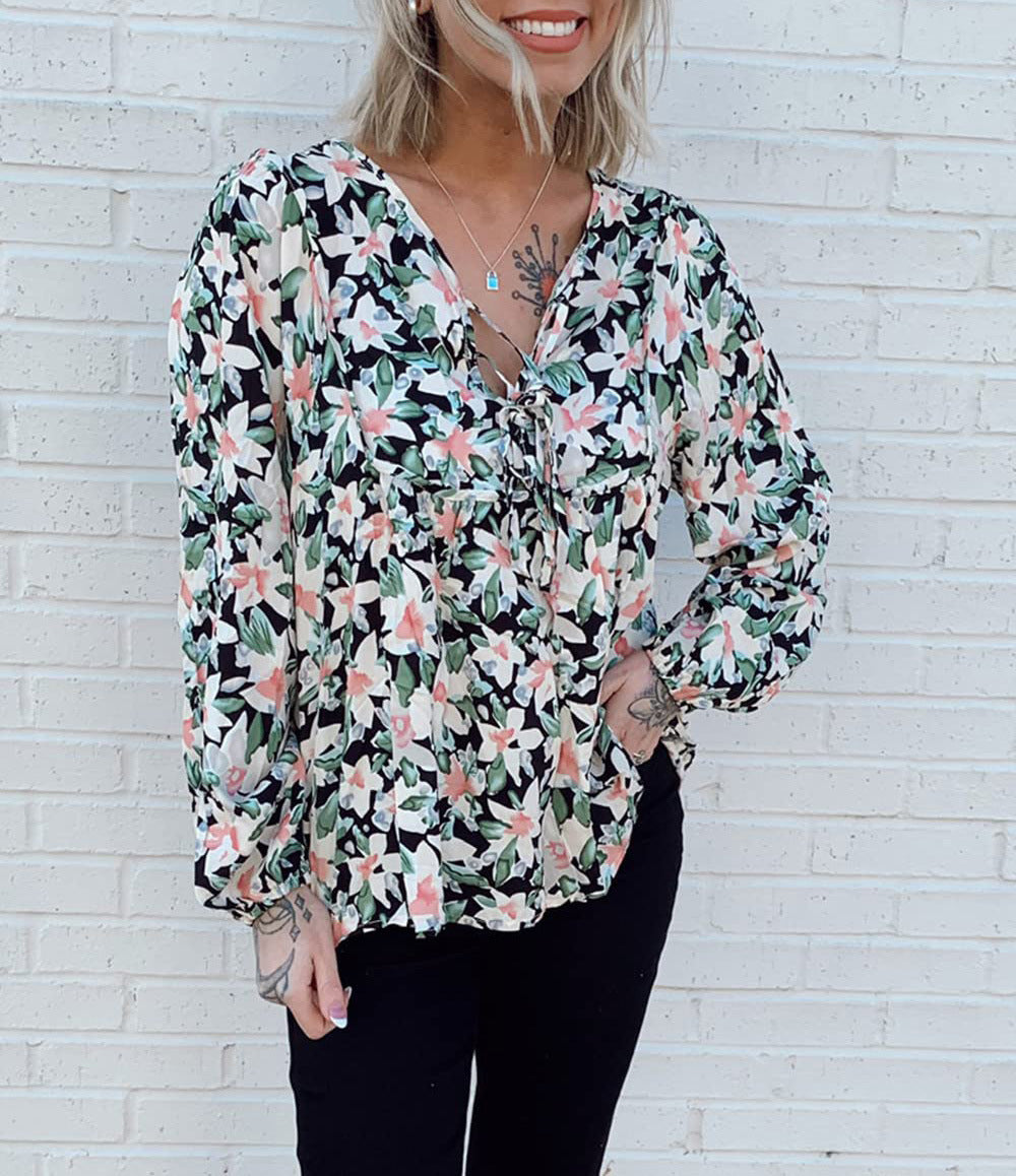 Floral print tie neck blouse with ruffle peplum