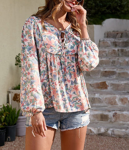 Floral print tie neck blouse with ruffle peplum