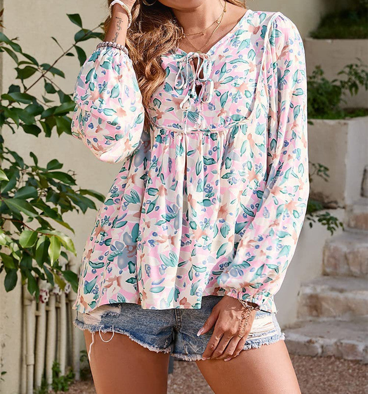 Floral print tie neck blouse with ruffle peplum