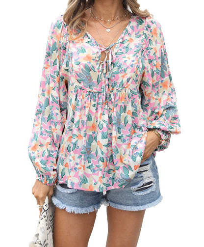 Floral print tie neck blouse with ruffle peplum