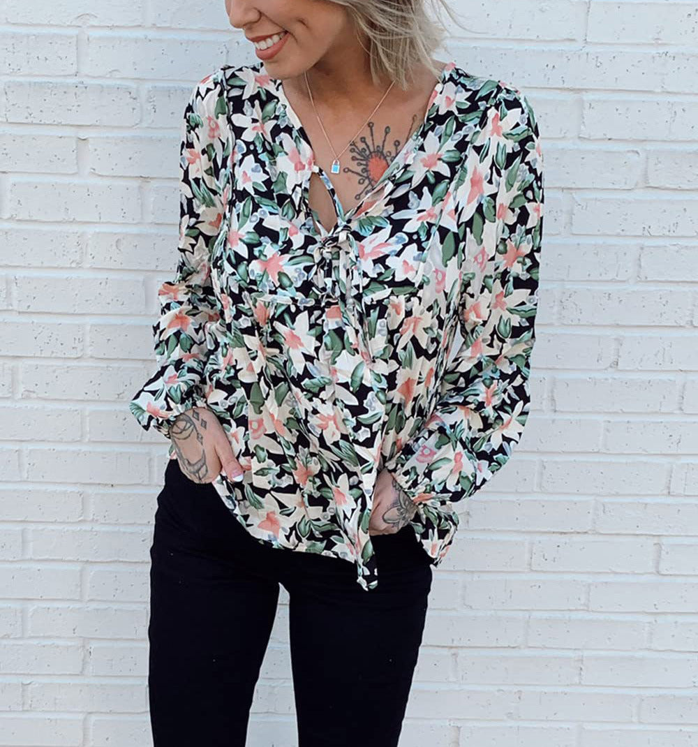 Floral print tie neck blouse with ruffle peplum