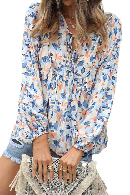 Floral print tie neck blouse with ruffle peplum
